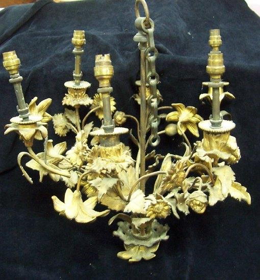 Appraisal: A gilt metal six-branch candelabra cast with flowers and floral