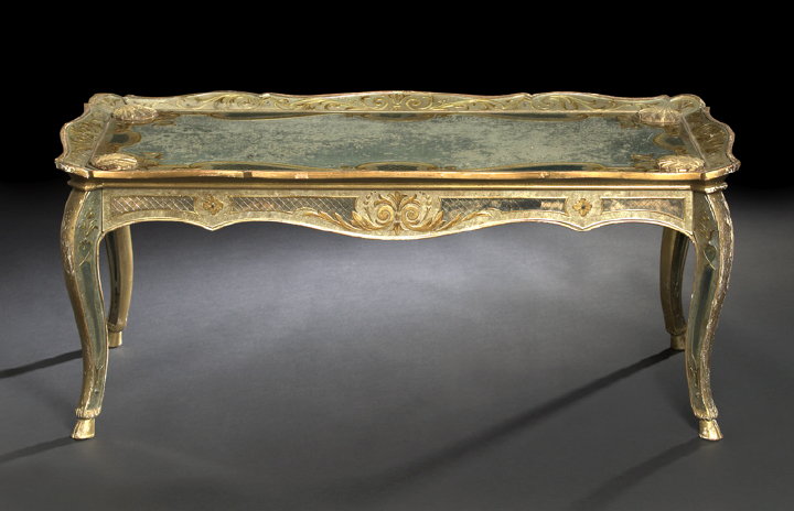 Appraisal: Italian Carved Giltwood and Reverse-Engraved Parcel-Gilt Mirrored Glass-Inset Cocktail Table