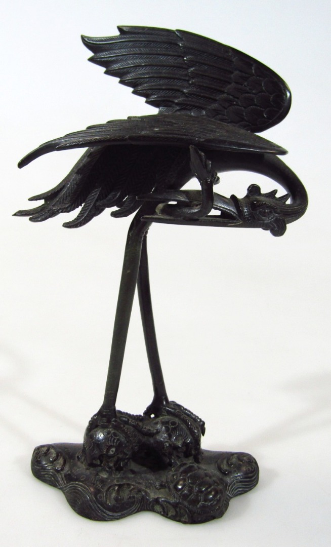 Appraisal: A Japanese bronze figure group of a standing stork with