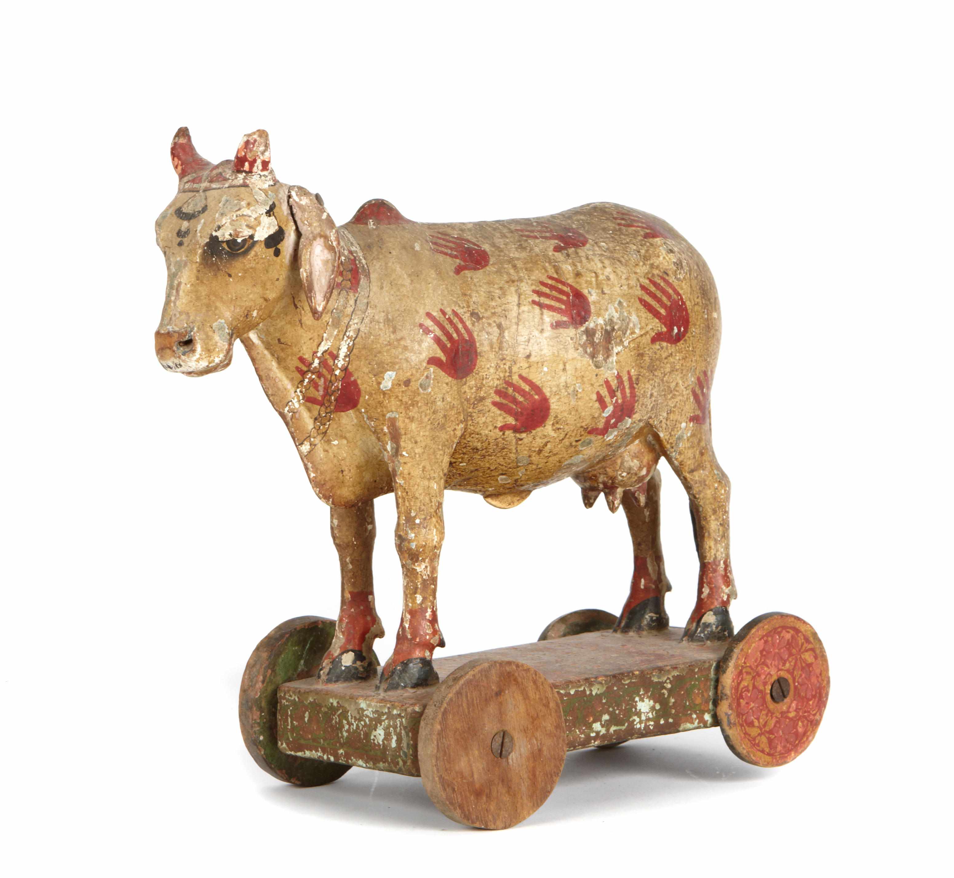 Appraisal: A painted wooden cow on wheels height in length in