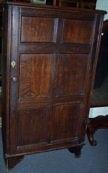 Appraisal: An oak cupboard with panelled door cm wide