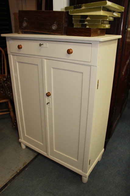 Appraisal: A PINE AND WHITE PAINTED CUPBOARD with single drawer over