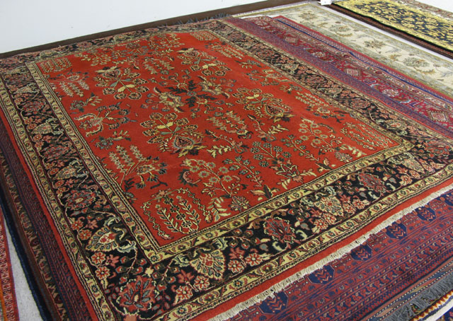 Appraisal: ORIENTAL INDO-SAROUK CARPET floral sprigs scattered across a red field