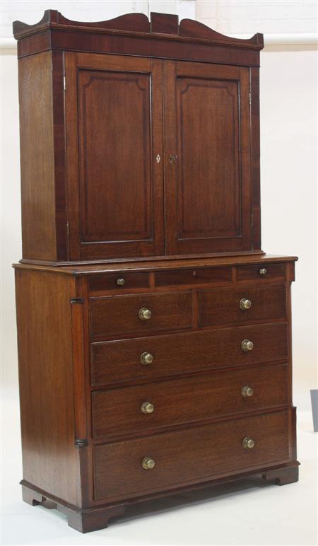 Appraisal: An early th century oak and mahogany cabinet on chest