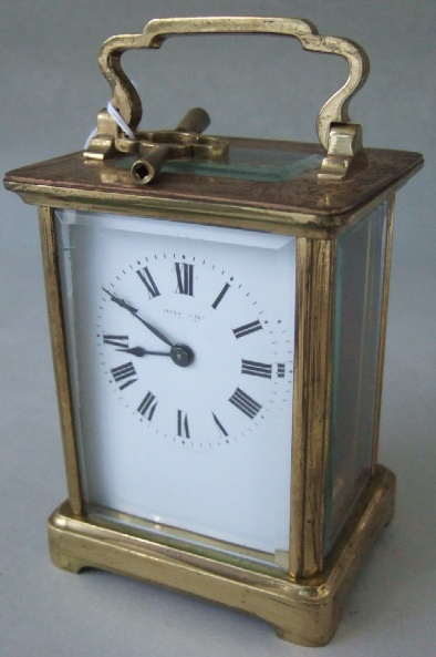 Appraisal: A gilt brass cased carriage clock with white enamel dial