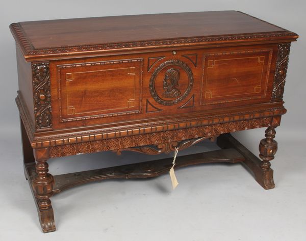 Appraisal: s carved walnut chest on legs with medallion head in