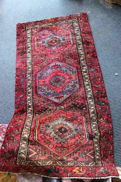 Appraisal: A WINE GROUND HAMADAN RUG with triple medallion and inside