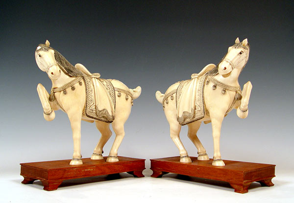 Appraisal: PAIR OF CHINESE CARVED IVORY HORSES Pair of prancing horses