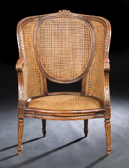 Appraisal: Louis XVI-Style Walnut Bergere late th century the caned medallion