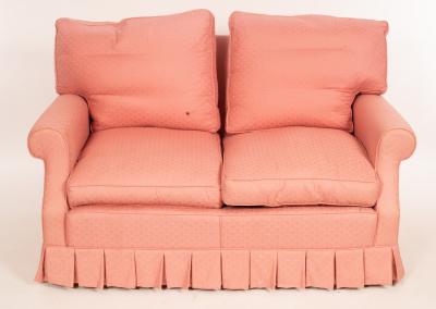 Appraisal: A two-seater sofa upholstered in pink fitted loose seat and