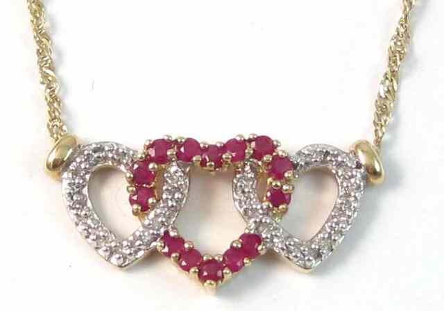 Appraisal: RUBY AND DIAMOND PENDANT NECKLACE Set between two equal lengths