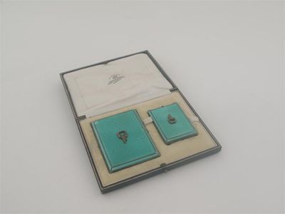 Appraisal: An art deco cigarette case and matching book match holder