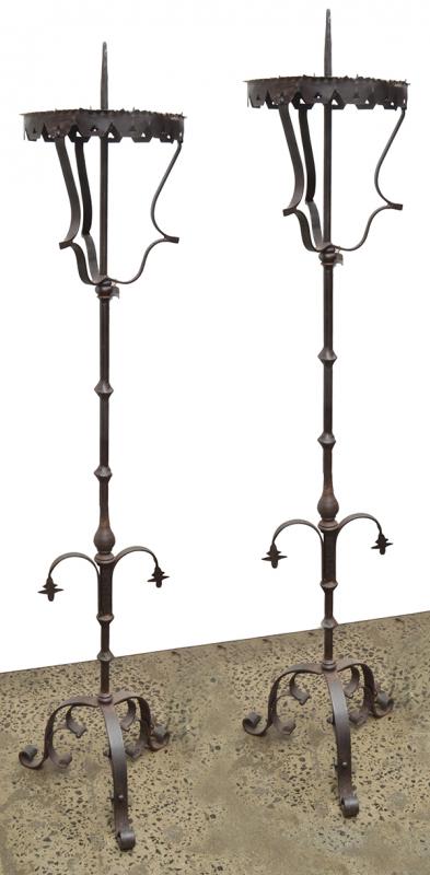 Appraisal: A PAIR OF WROUGHT IRON TORCHERESeach with a knopped stem