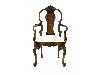 Appraisal: A WALNUT ELBOW CHAIR the carved spoon shaped back crested