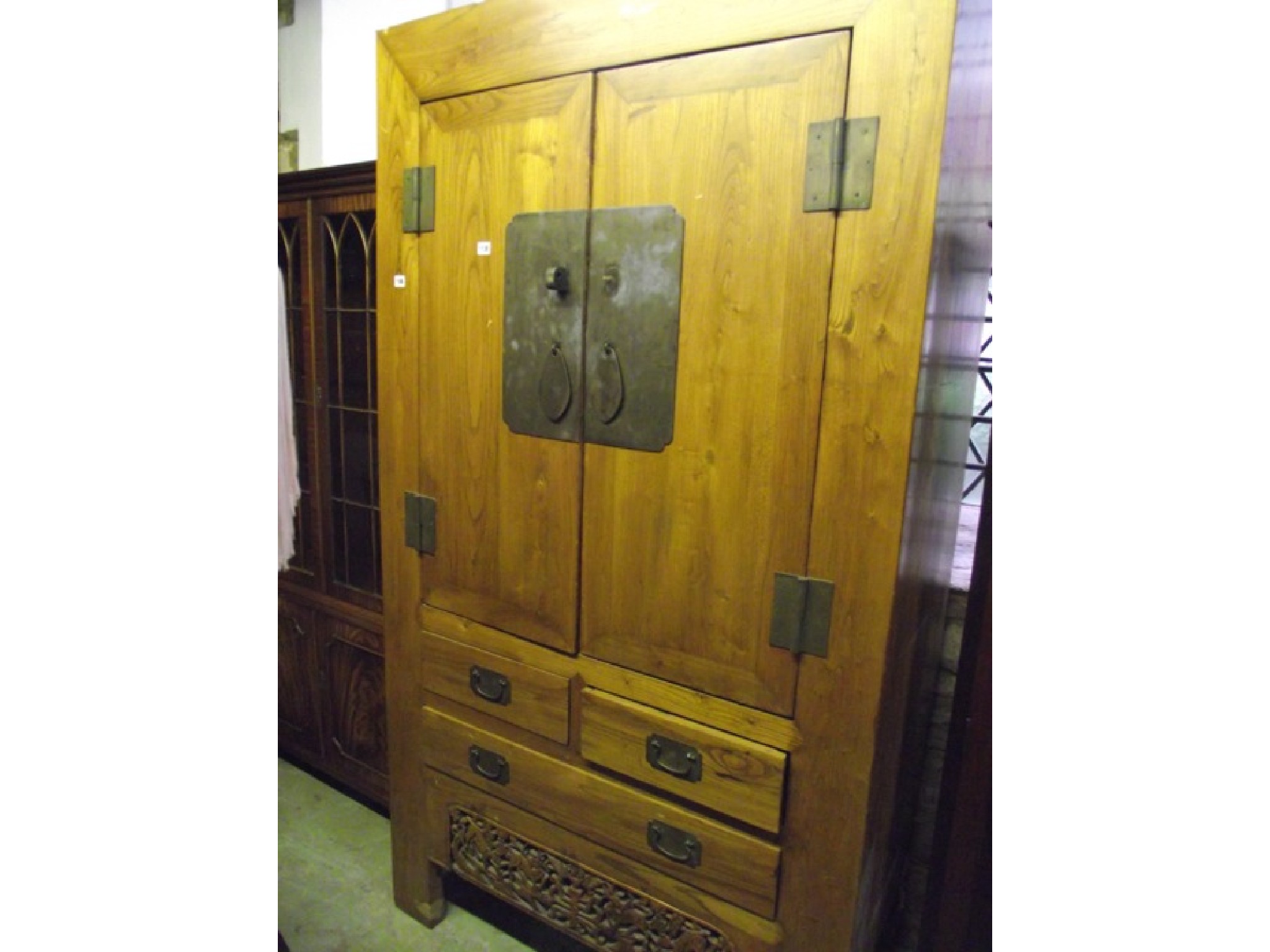 Appraisal: A Chinese elm wardrobe side cupboard partially enclosed by a