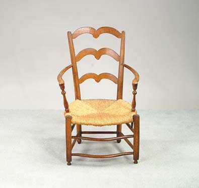 Appraisal: FRENCH ANTIQUE COUNTRY ARMCHAIR Three shaped ladderback tapered molded edge