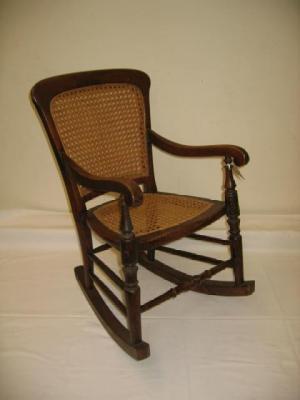 Appraisal: A VICTORIAN CHILD'S BEECHWOOD ROCKING CHAIR with caned seat and