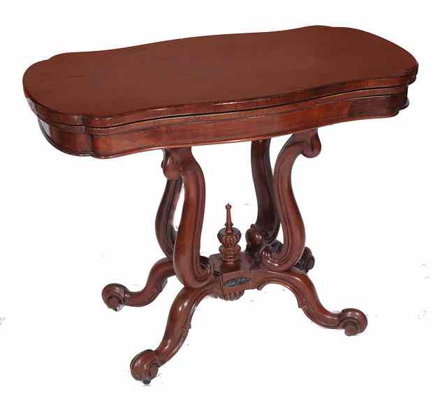 Appraisal: A VICTORIAN MAHOGANY SERPENTINE FOLD OVER CARD TABLE having a