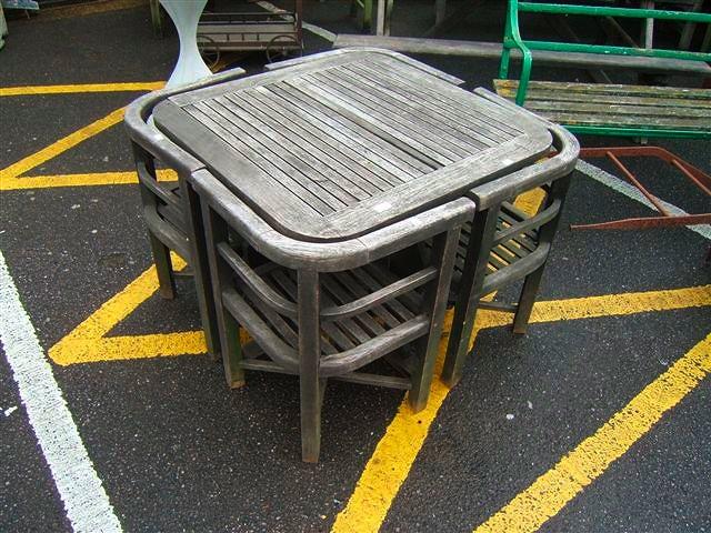 Appraisal: A square garden table with slatted top and shaped supports