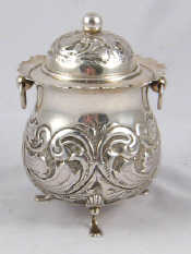 Appraisal: A silver tea caddy with ring handles shell and pad