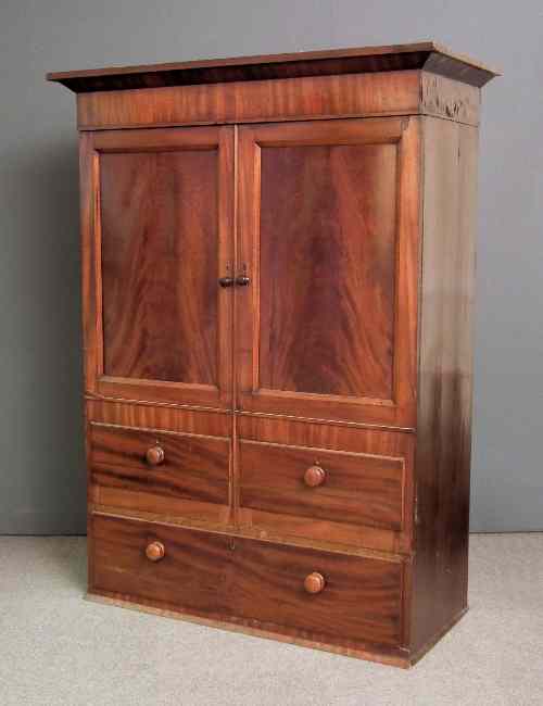 Appraisal: A Victorian mahogany dwarf wardrobe the top with angled cornice