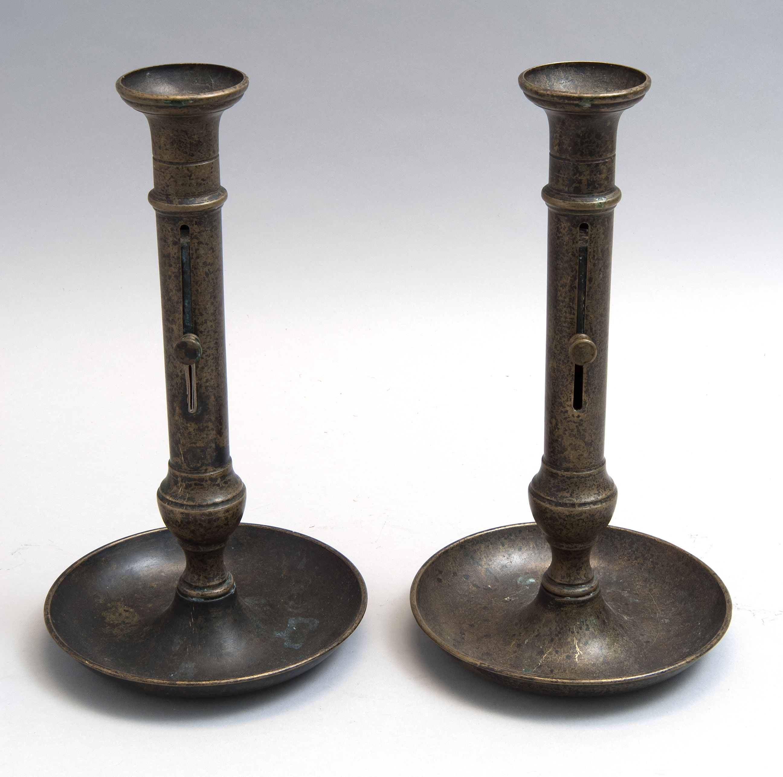 Appraisal: PAIR OF BRASS PUSH-UP CANDLESTICKS Continental Late th CenturyWith saucer-form