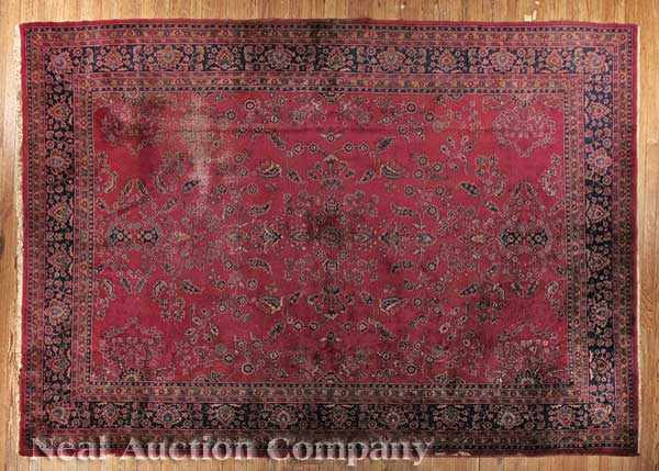 Appraisal: A Large Sarouk Carpet red ground meandering floral motifs ft