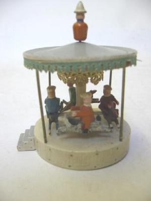 Appraisal: An Erzeberg roundabout painted wood construction with moving figures G