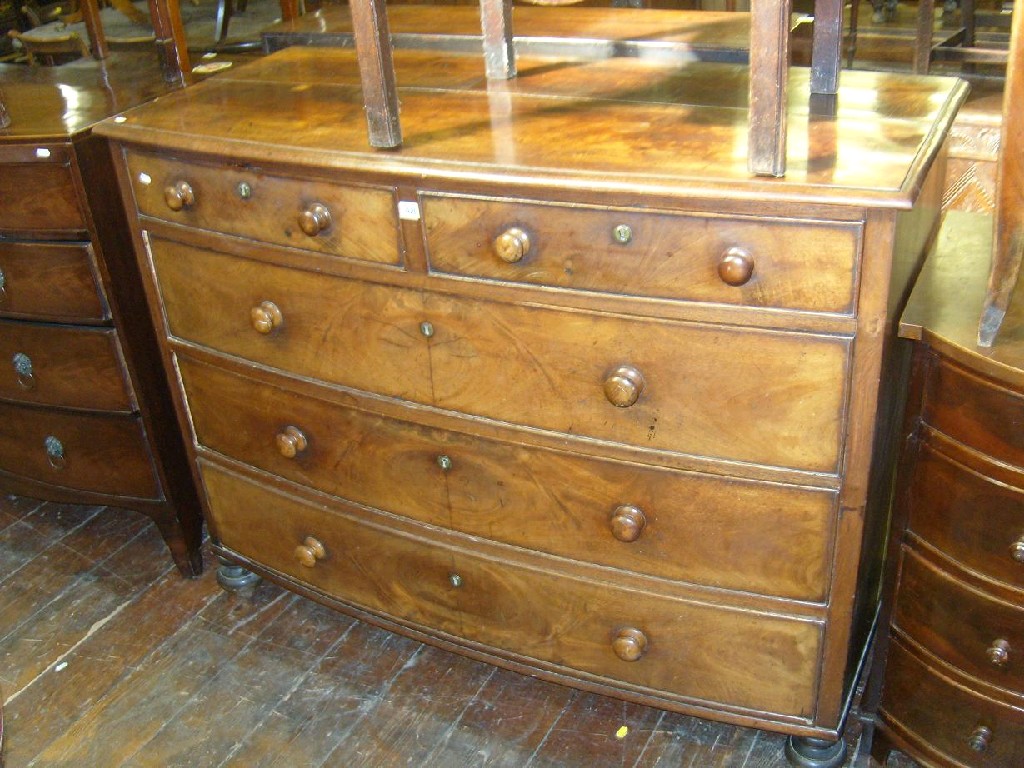 Appraisal: An early Victorian mahogany bow front chest with three long