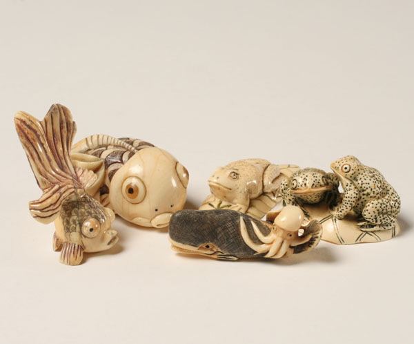 Appraisal: Five Japanese carved ivory netsukes fish frogs and a whale