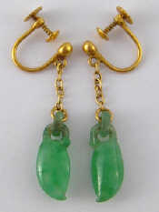 Appraisal: A pair of Chinese carved jade and gold earrings screw