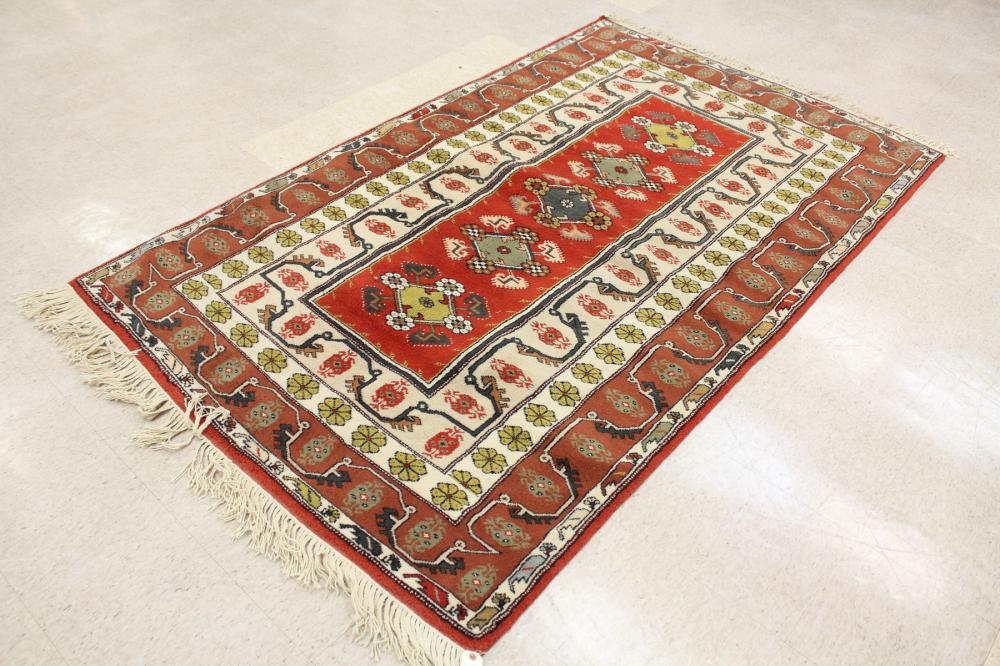 Appraisal: HAND KNOTTED TURKISH AREA RUG centering a column of five