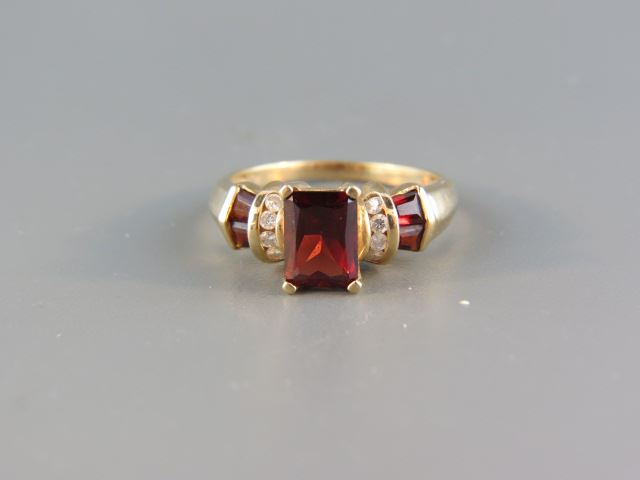 Appraisal: Garnet Diamond Ring emerald cut rich center garnet with diamonds