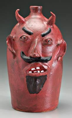 Appraisal: Louis Brown devil jug broken china teeth red painted with