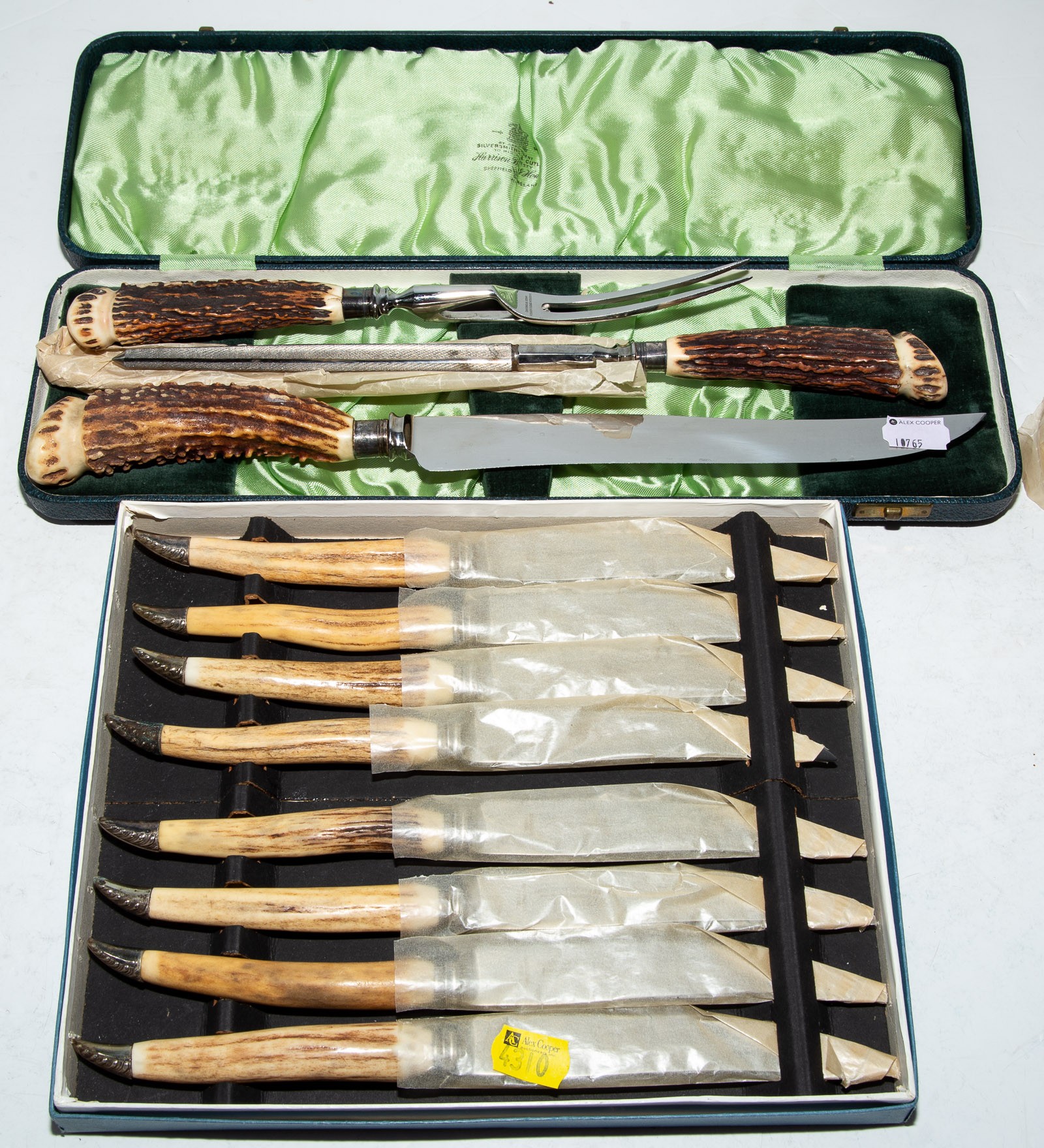 Appraisal: ENGLISH ANTLER-HANDLED CARVING SET STEAK KNIVES Three-piece carving set by