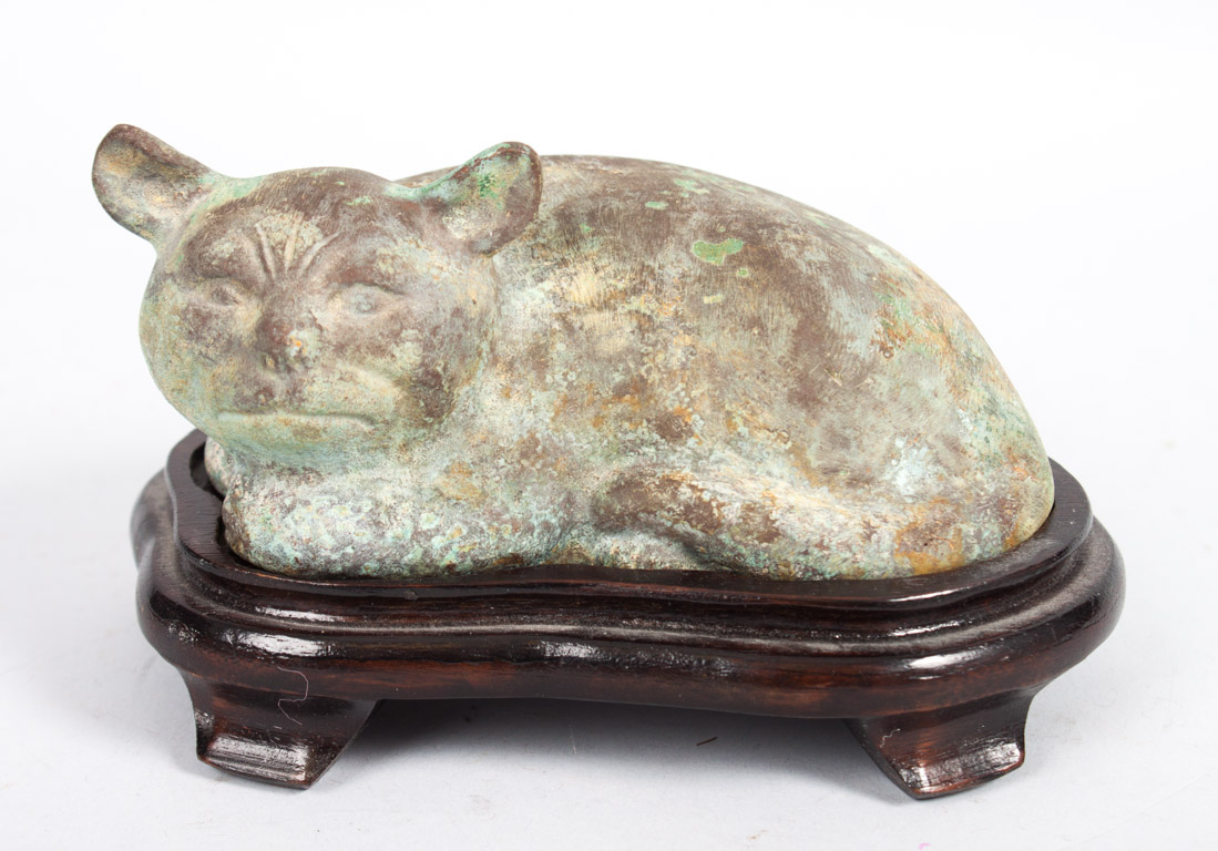 Appraisal: Chinese archaic style bronze cat modeled as resting cat on