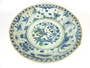 Appraisal: Large Persian blue and white charger painted with a central