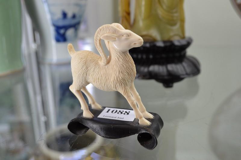 Appraisal: IVORY CARVING OF A RAM ON A TIMBER BASE