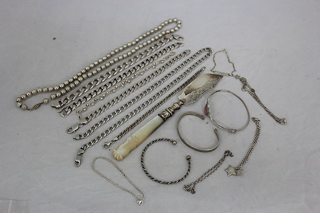 Appraisal: FOUR SILVER INTERLINKED WRIST CHAINS a silver mother of pearl