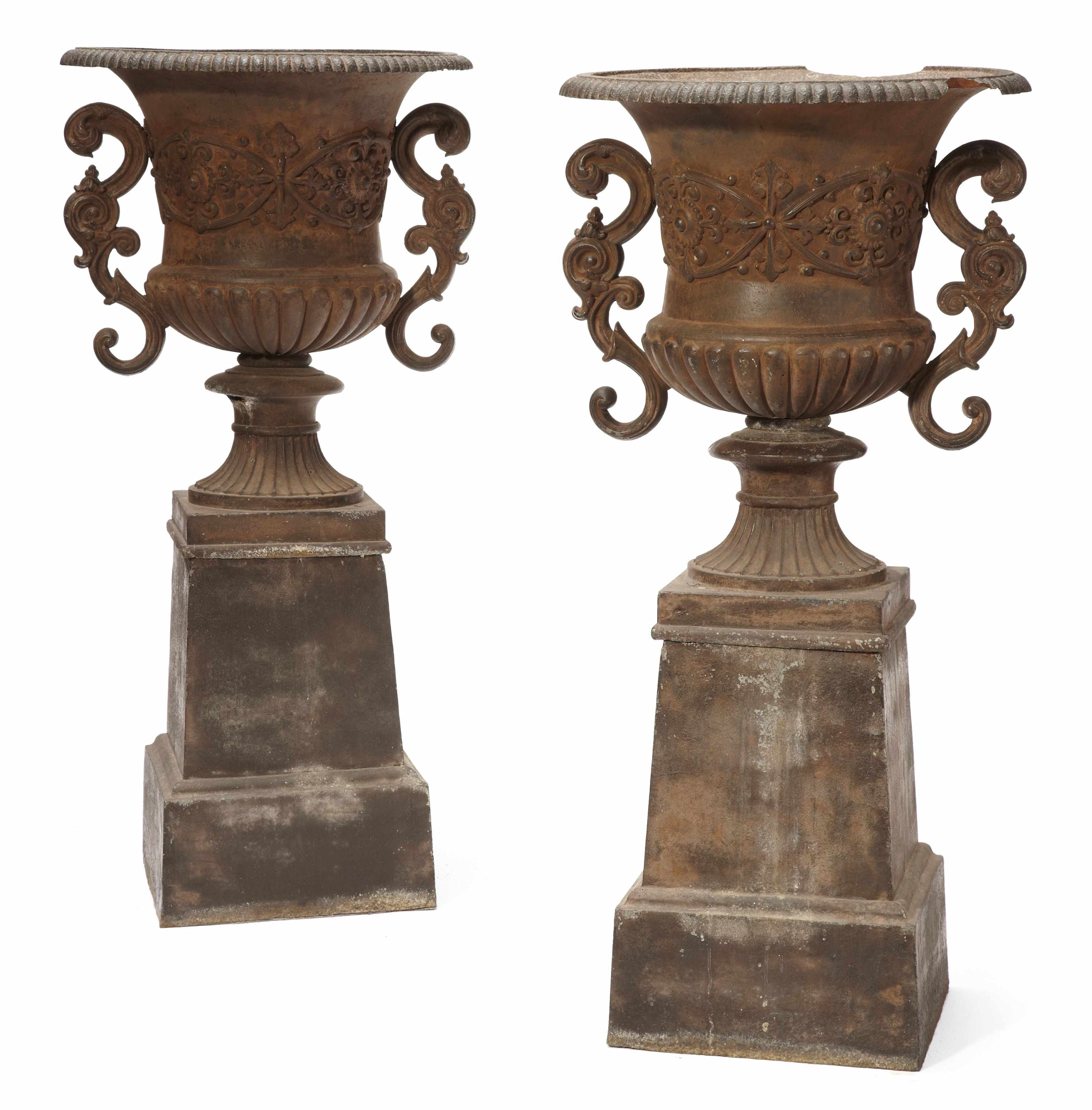 Appraisal: A pair of Neoclassical style cast iron garden urns on