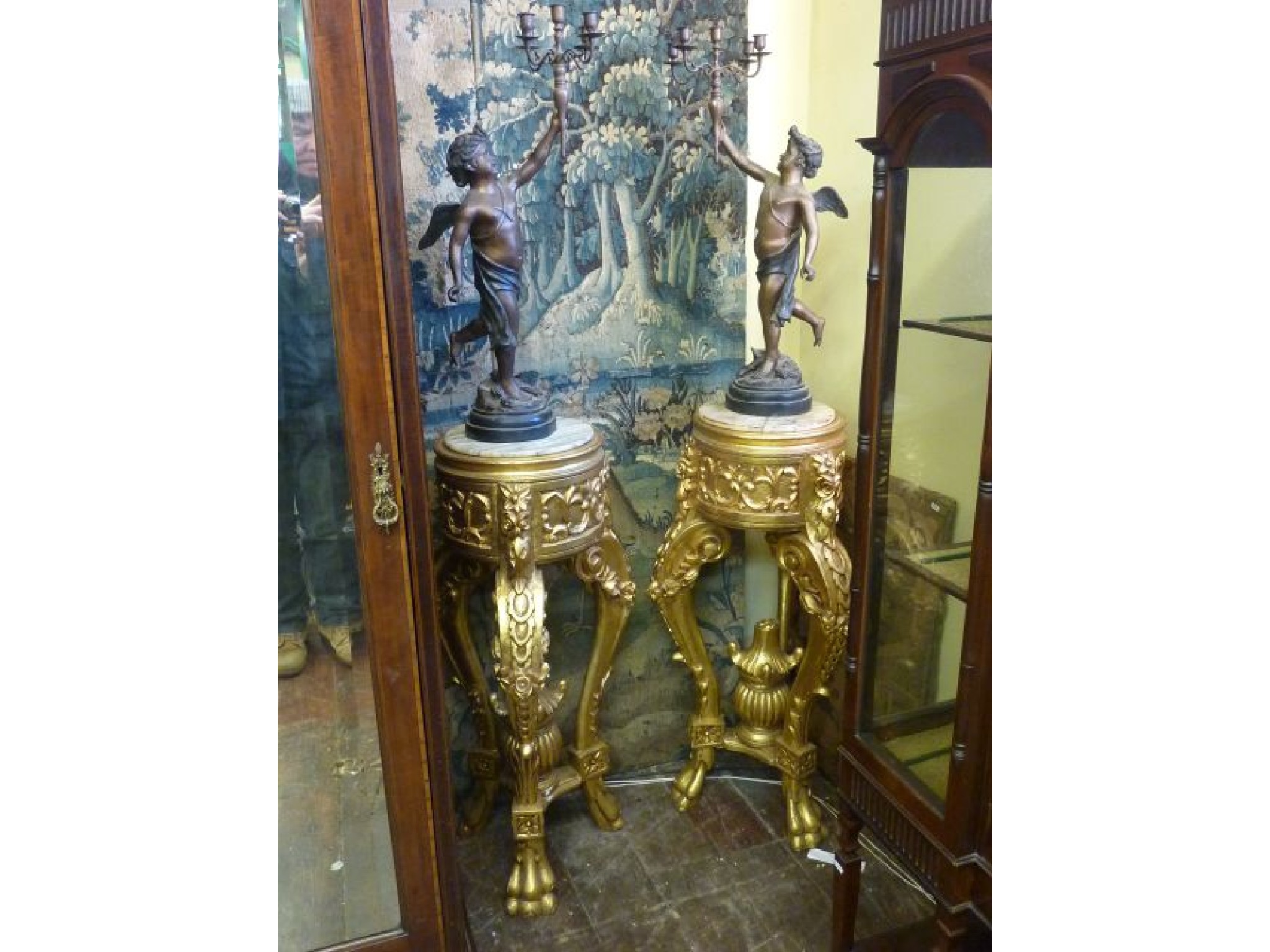 Appraisal: A pair of gilded torcheres with carved finish and inset