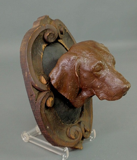 Appraisal: Carved wood hound head mounted on an ornately carved plaque