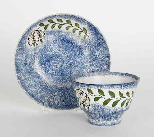 Appraisal: Blue spatter cup and saucer th c with tulip variant