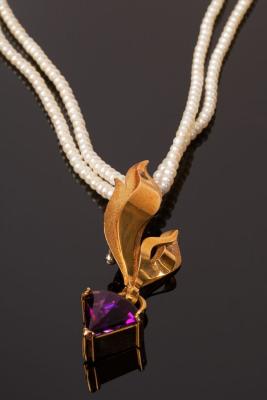 Appraisal: An amethyst pendant the ct amethyst of triangle-shape suspended from