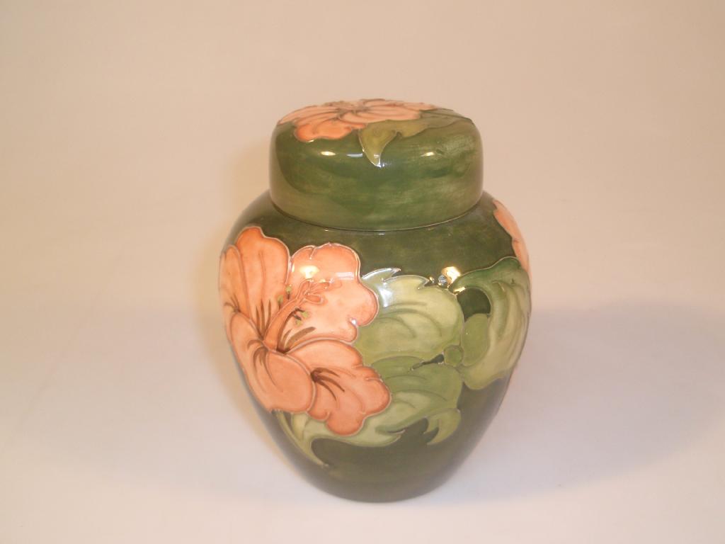 Appraisal: Moorcroft A lidded ginger jar green with orange hibiscus paper