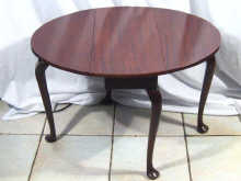 Appraisal: An oval solid mahogany tea table with drop down leaves