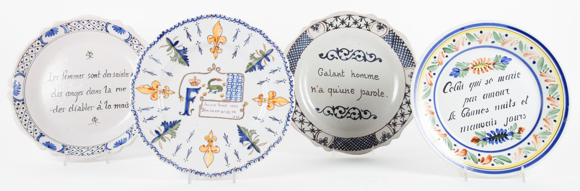 Appraisal: Four French faience motto decorated plates th th centuries each