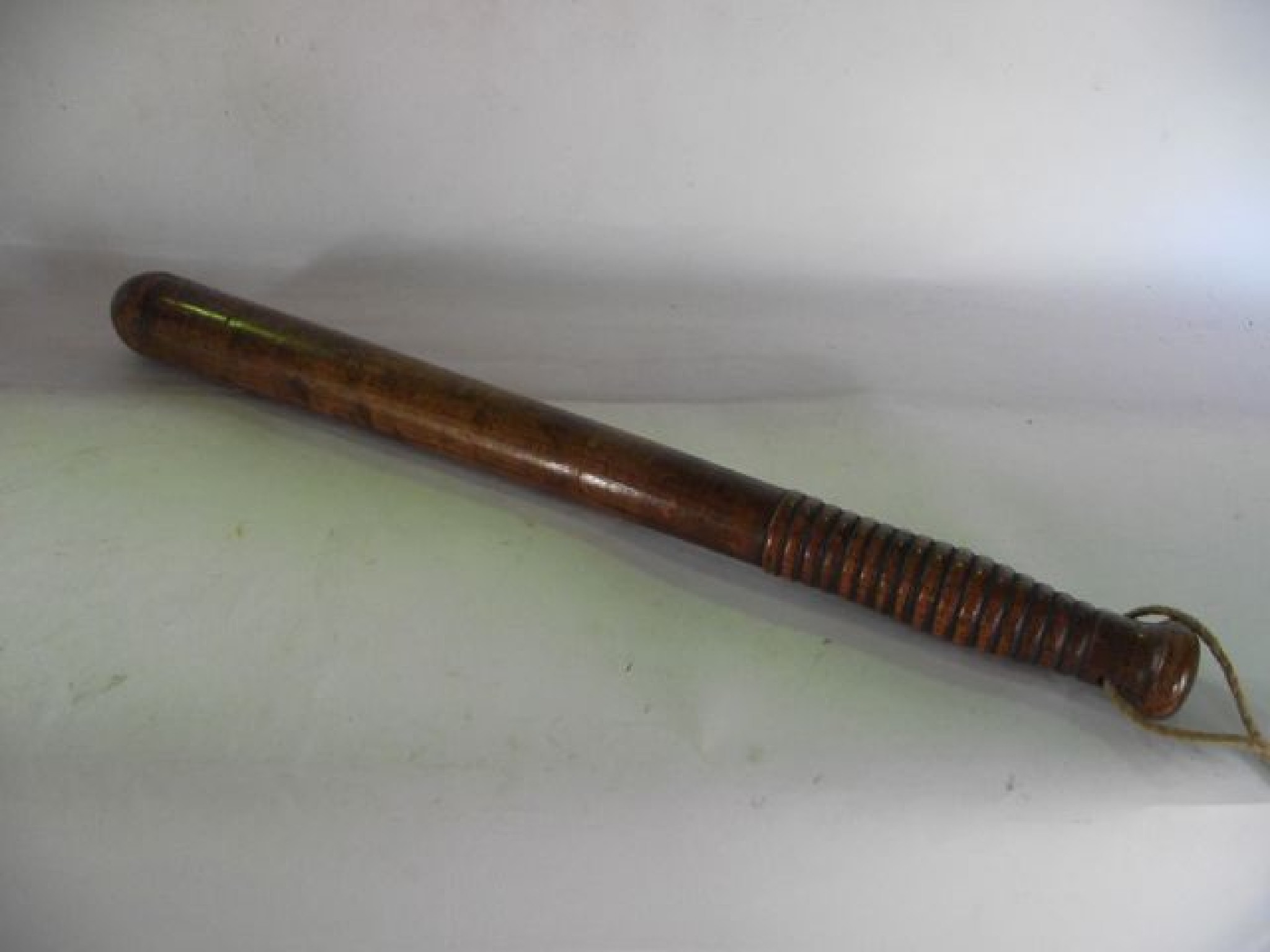 Appraisal: A polished oak truncheon stamped MP