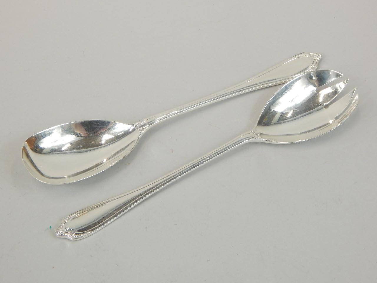 Appraisal: A pair of Elizabeth II silver salad servers with shaped