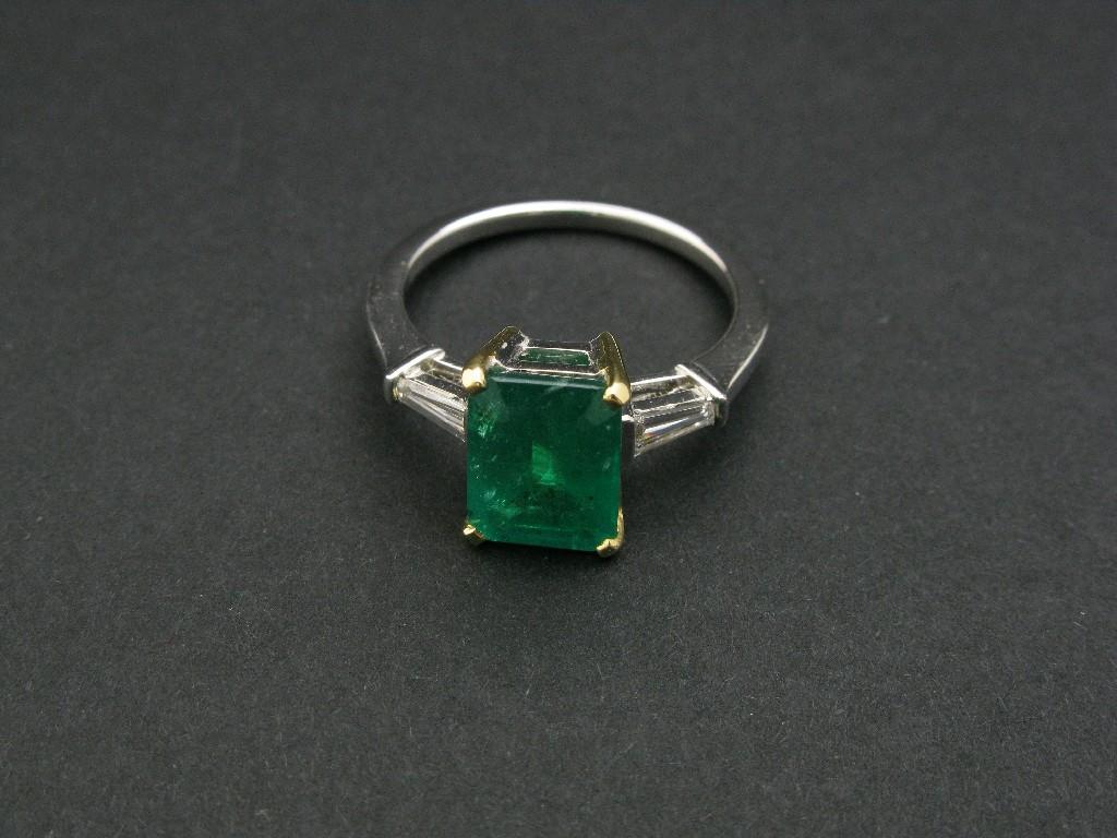 Appraisal: A Contemporary Emerald and Diamond Ring claw set central step-cut